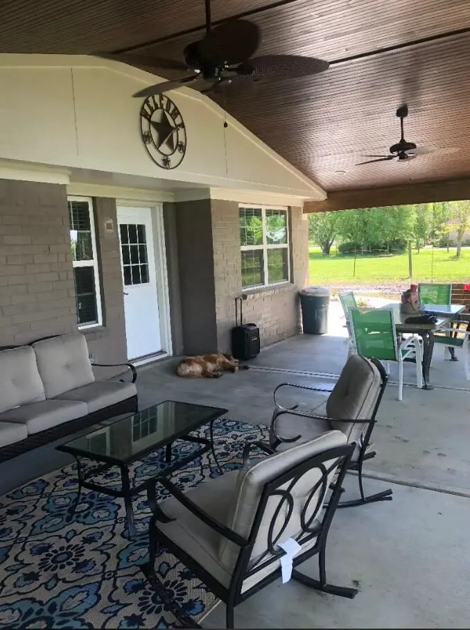 Two Ceiling Fans, Chairs, Table, Dog, and Patio Cover