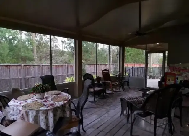 A patio with tables and chairs in the middle of it.