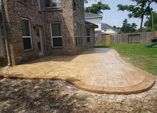 A brick patio with a large concrete slab.