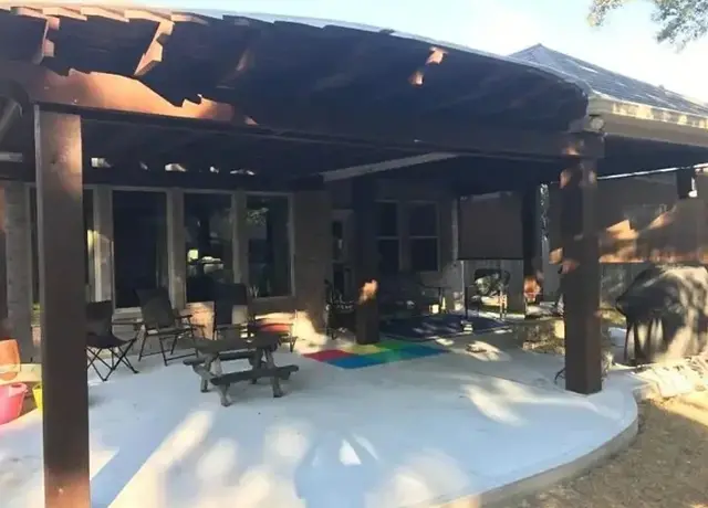 A patio with a fire pit and covered area.