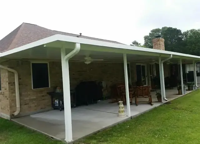 A patio cover with an open roof and a fire hydrant.