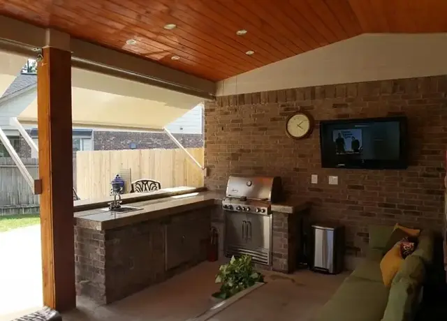 A kitchen with an oven and a television.