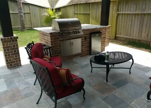 A patio with chairs and tables outside of the house