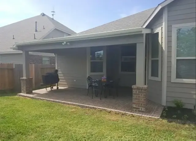 A patio with an awning over the back of it