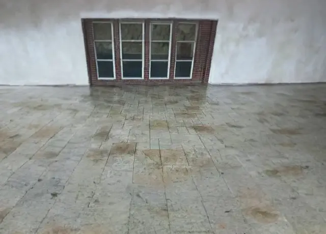 A room with a window and tiled floor