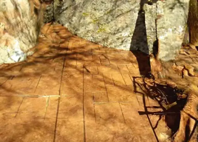 A wooden deck with a chair and umbrella.