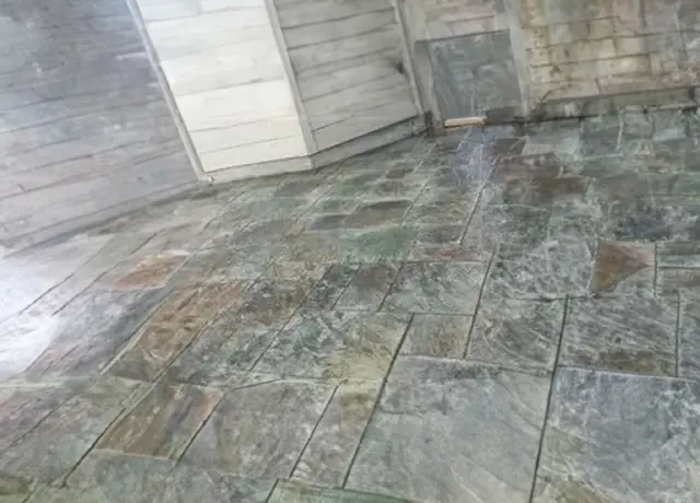 A stone floor with many different colors of stones.