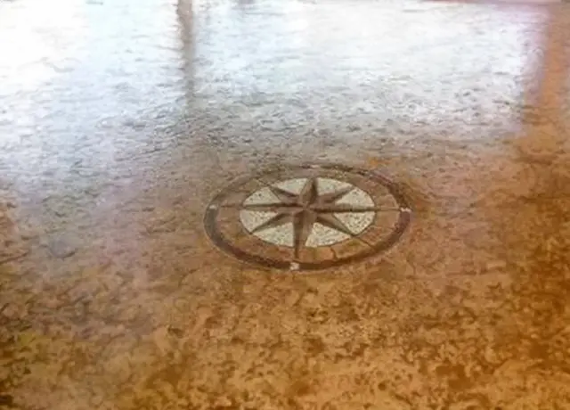 A floor with a compass on it