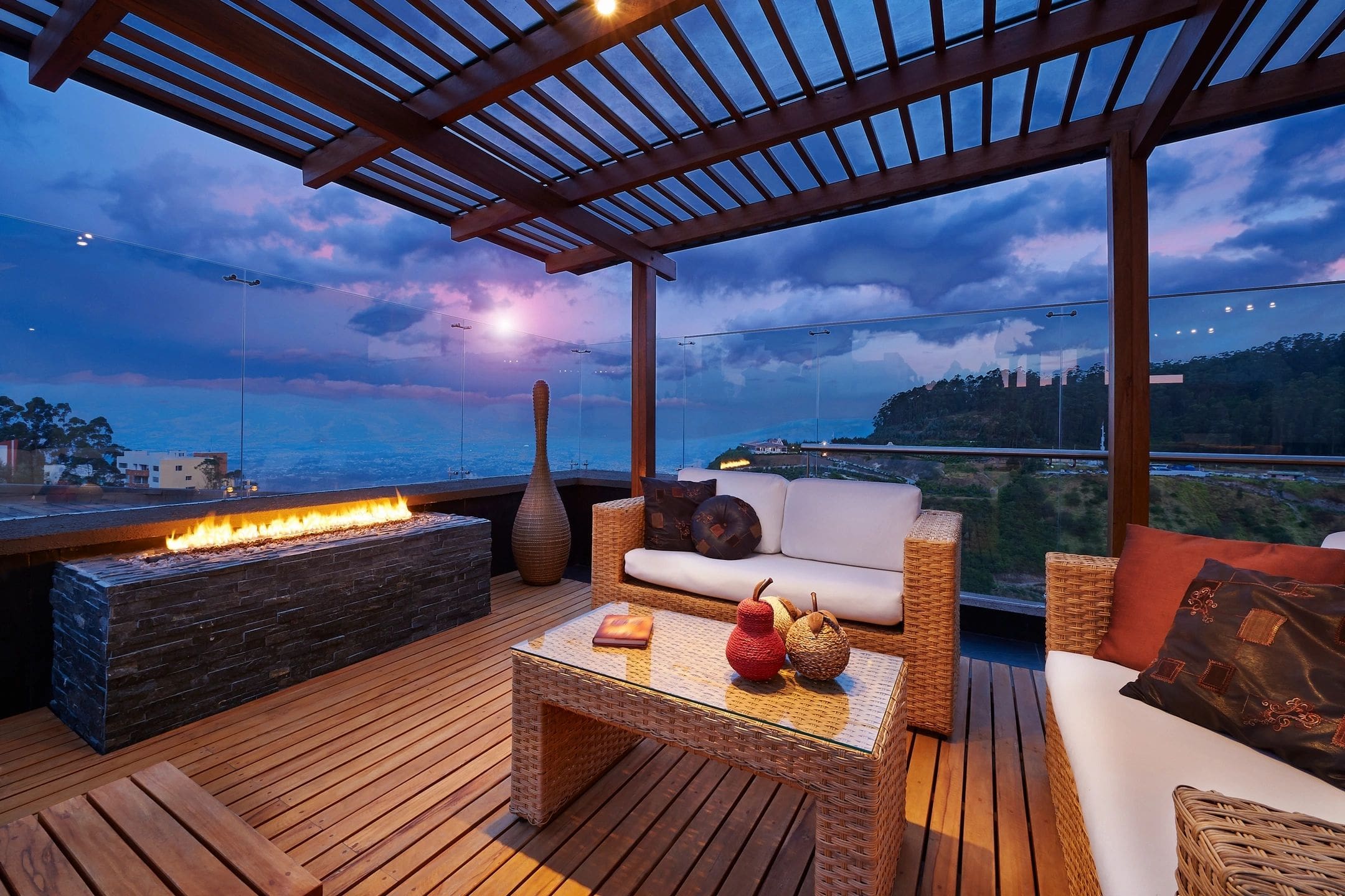 A deck with furniture and fire pit on top of it.